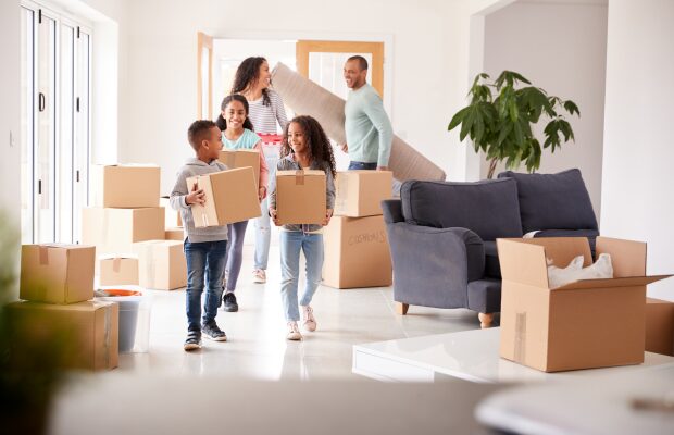 Family entering their new Saltaire home with moving boxes