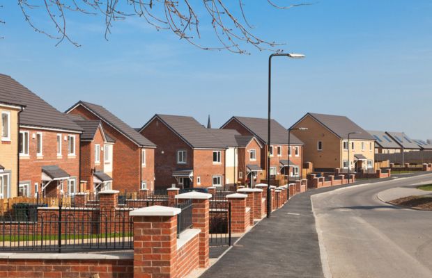 Residential street with modern houses and clear blue sky