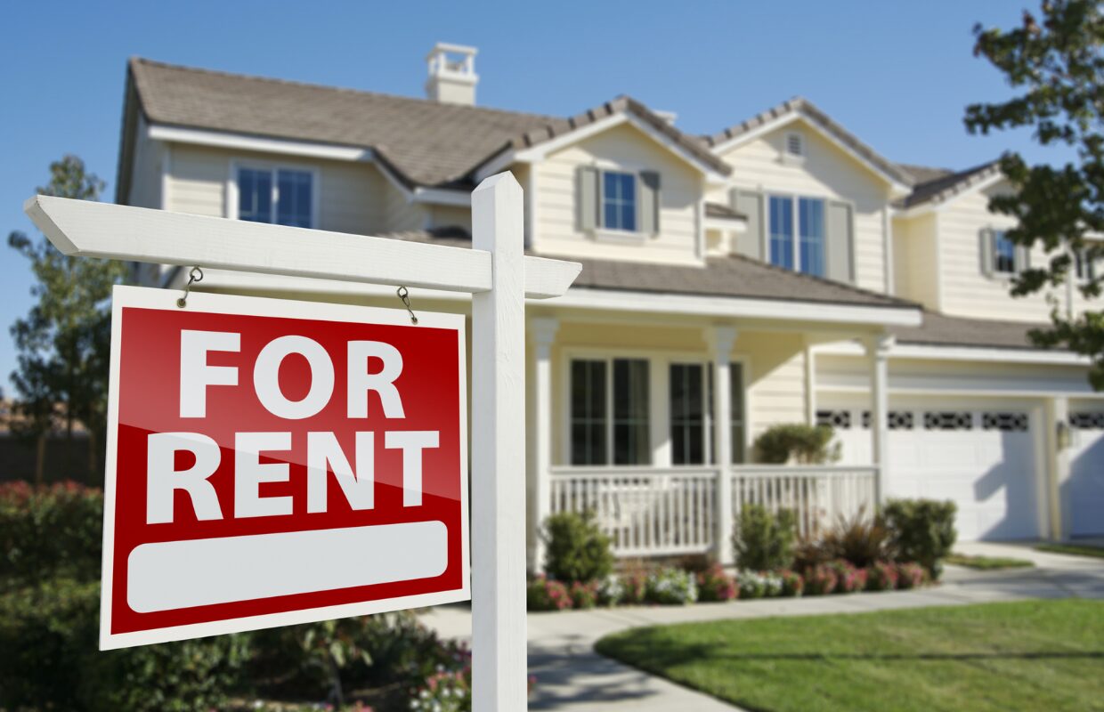 Red and white "For Rent" sign outside a detached home with a lawn in Keighley