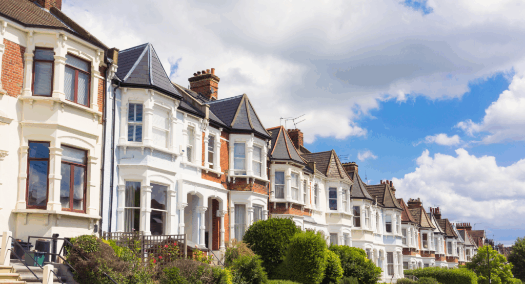 Row of traditional UK terraced homes on a sunny day, representing Martin & Co’s 2025 landlord guide on how to set competitive rental prices.