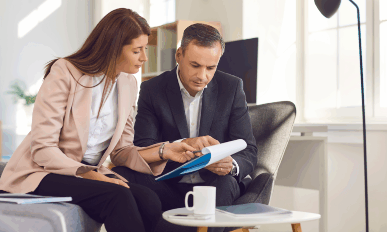 A landlord and letting agent reviewing documents together, discussing the end of Section 21 and upcoming Renters Reform changes.