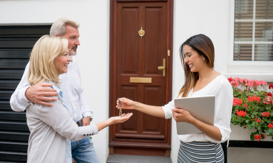 Letting agent handing over keys to landlords outside a Leamington Spa rental property as part of post-Christmas buy-to-let planning for 2026