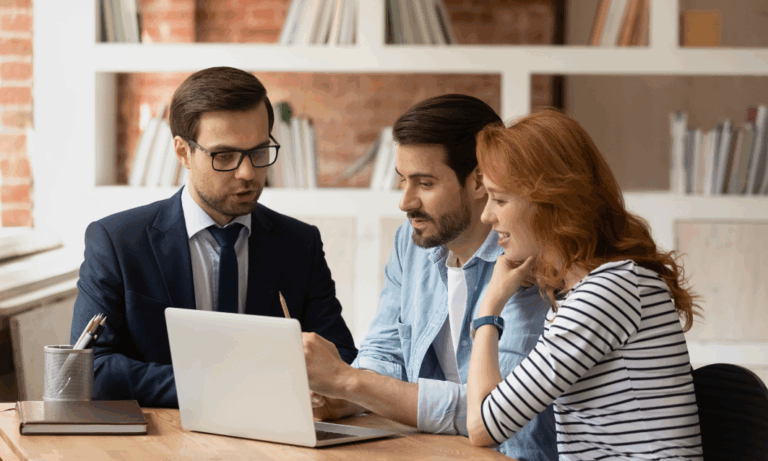 Buyers reviewing property prices and location options with an estate agent while comparing Westbury, Trowbridge and Warminster homes