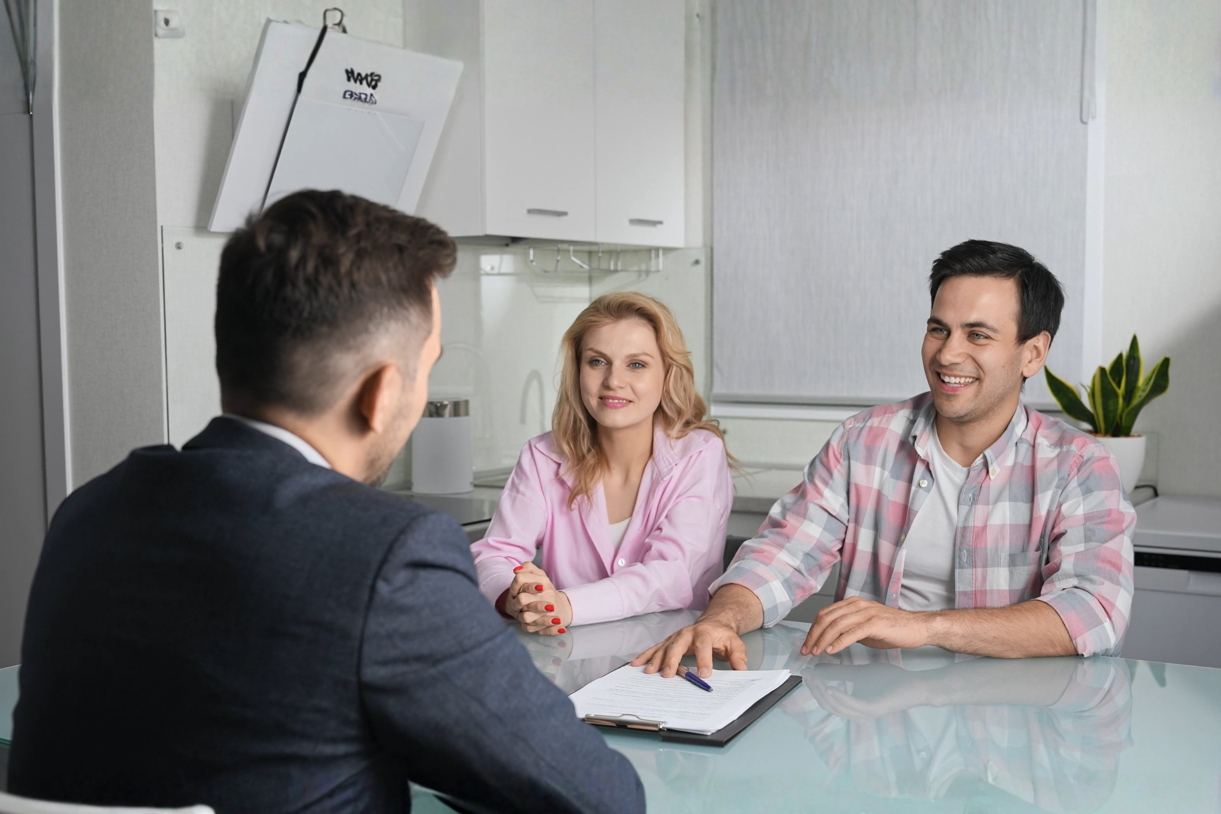 Letting agent meeting with renters at a kitchen table to discuss a tenancy, reflecting Oxford’s growing demand for energy-efficient “green” homes in 2026.