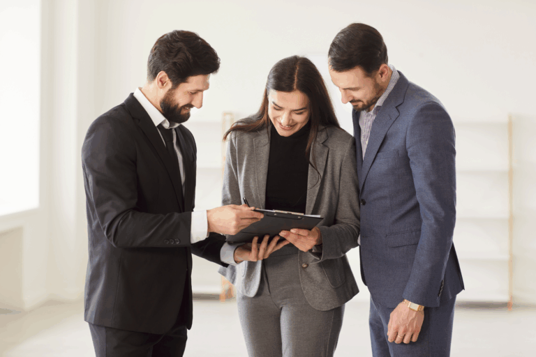 Letting agent reviewing a rent agreement on a clipboard with landlords, reflecting Worksop rent reviews and Section 13 compliance ahead of the May 2026 reforms.