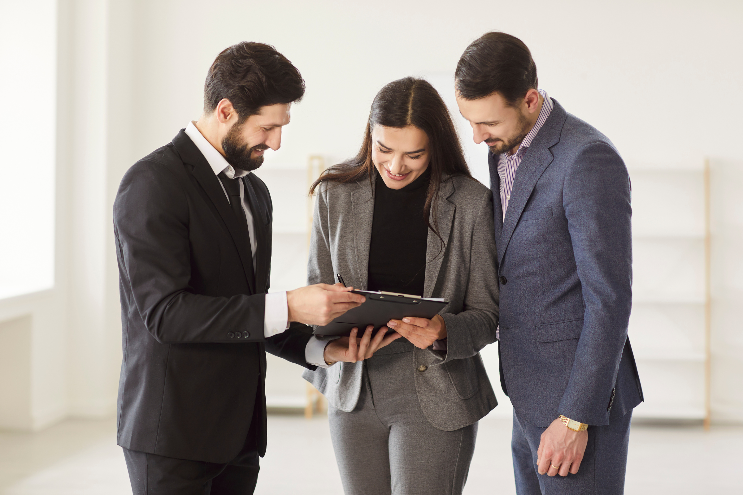 Letting agent reviewing a rent agreement on a clipboard with landlords, reflecting Worksop rent reviews and Section 13 compliance ahead of the May 2026 reforms.
