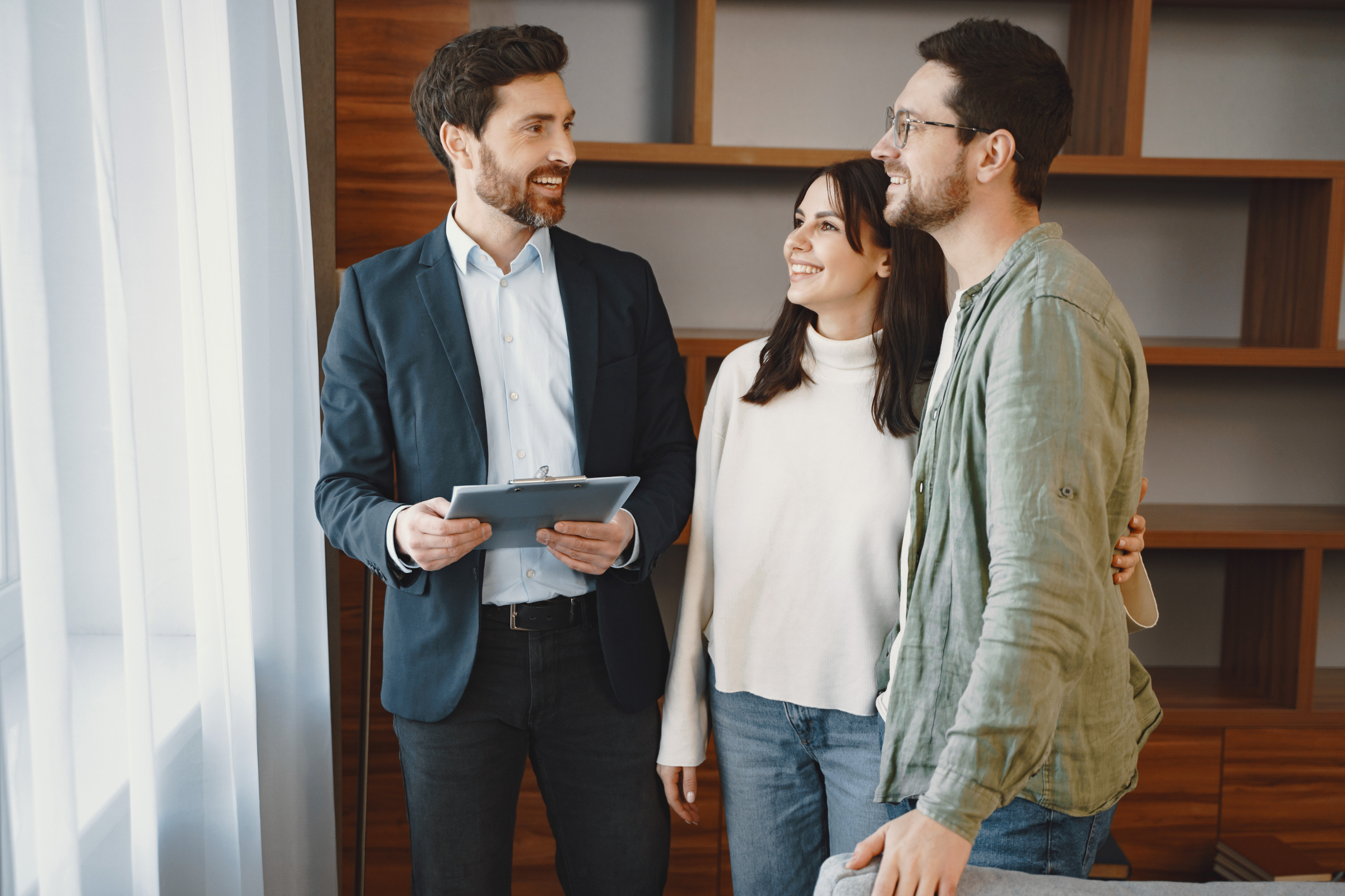 Letting agent speaking with a couple during a property viewing, reflecting how Paisley landlords can stay compliant with Local Place Plans and Scotland’s new rental standards in 2026.