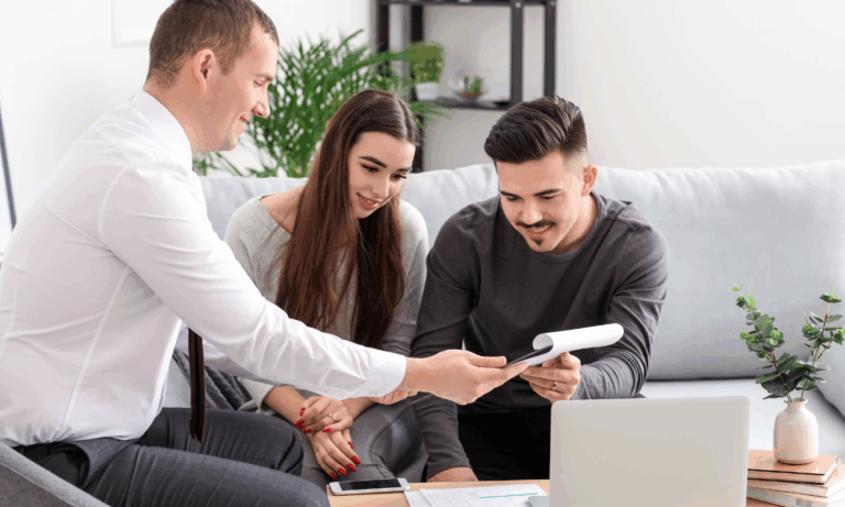 Homeowners reviewing property documents with an agent while discussing future plans in Worcester