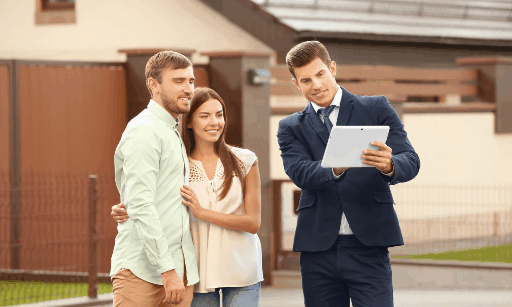 Estate agent showing a couple property information in Leamington Spa’s Creative Quarter area