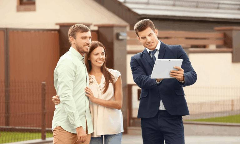 Estate agent showing a couple property information in Leamington Spa’s Creative Quarter area