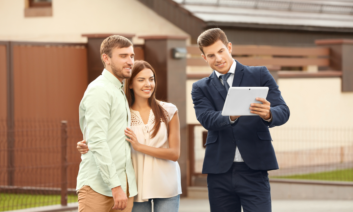 Estate agent showing a couple property information in Leamington Spa’s Creative Quarter area