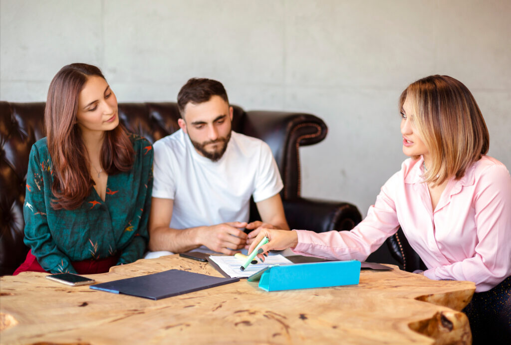 Landlords meeting an agent to review compliance and property management for a growing rental portfolio in Kingston in 2026