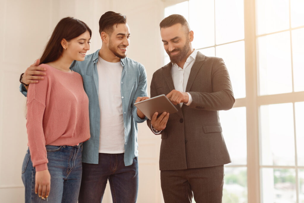 Estate agent showing homeowners market information in a bright property during February 2026 in North Cardiff