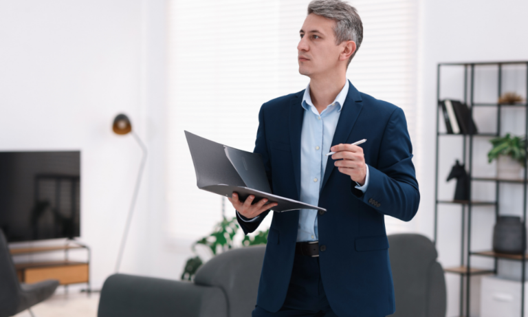 Property manager inspecting a rental property with laptop to ensure compliance with Awaab’s Law in Aberdeen