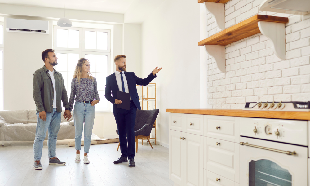 Estate agent showing a property to a couple during a home viewing related to selling property in Widnes.