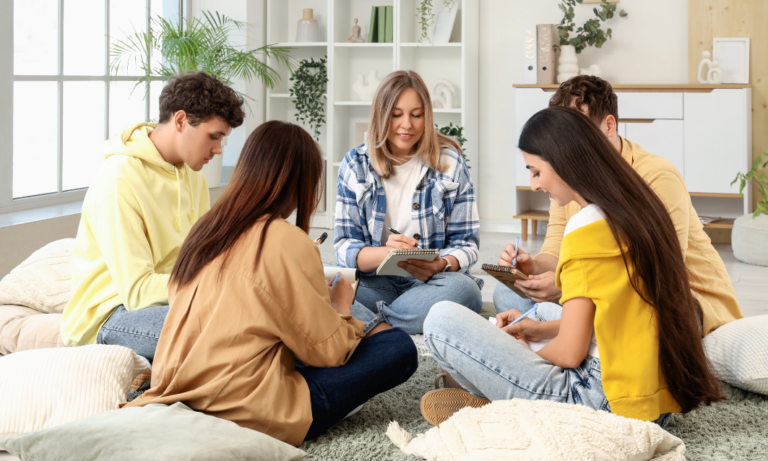 Group of students sitting together in a shared living space, representing student HMOs and property management in Oxford