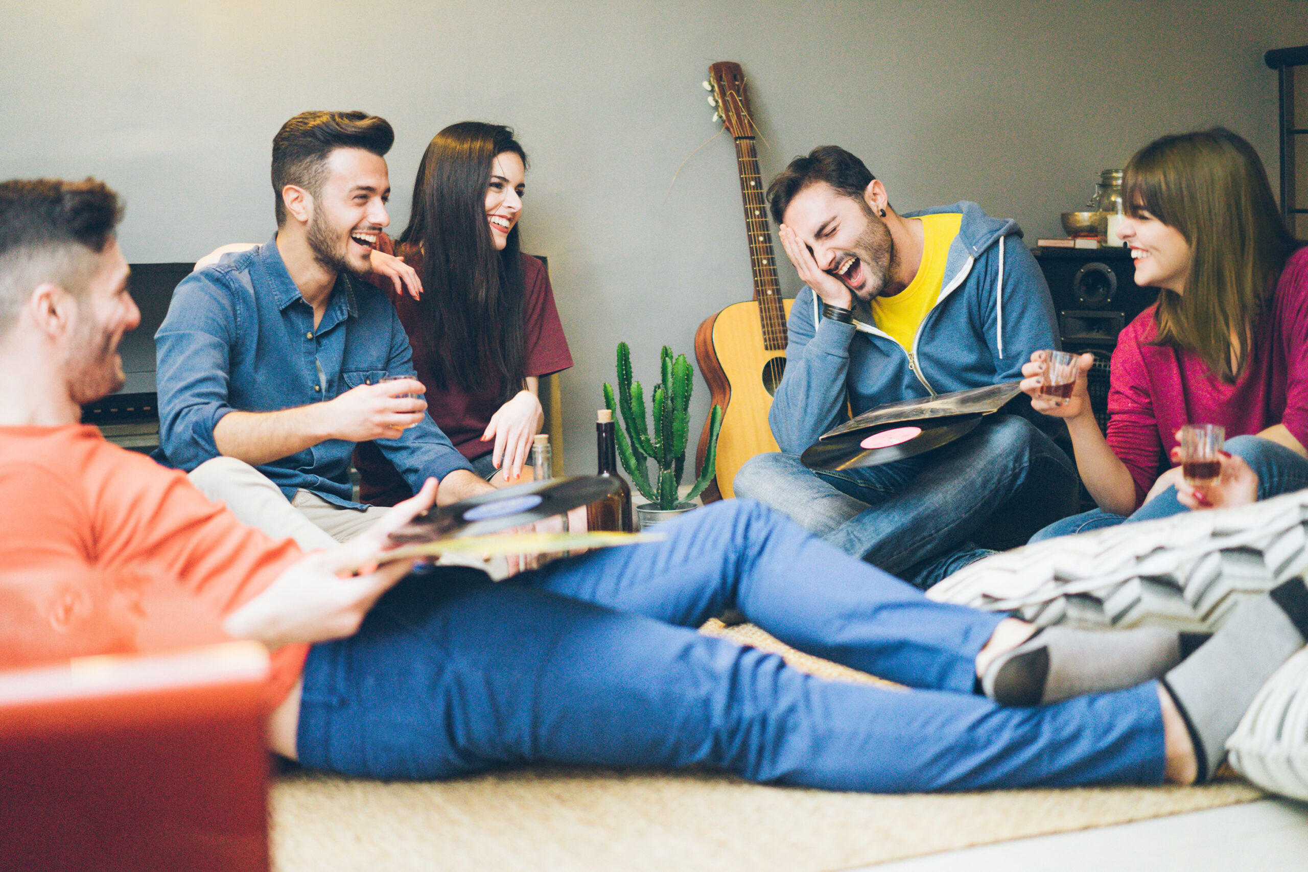 Group of university students relaxing in a shared living room, representing student accommodation in the Stirling rental market.