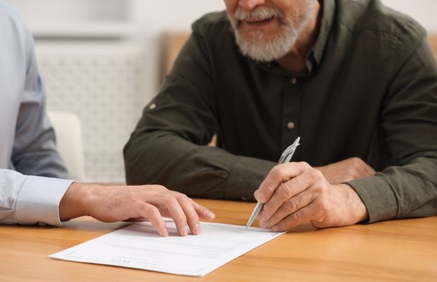 Two people discussing a document on a table.