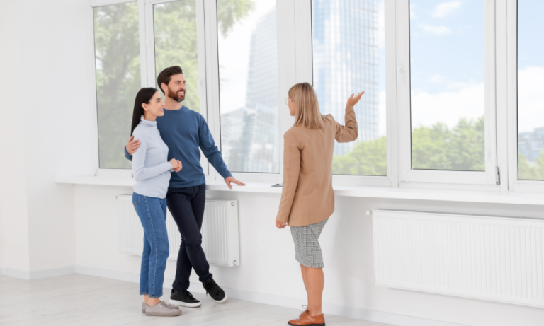 Couple viewing a rental property with a letting agent, representing landlords meeting the Decent Homes Standard in the private rented sector.