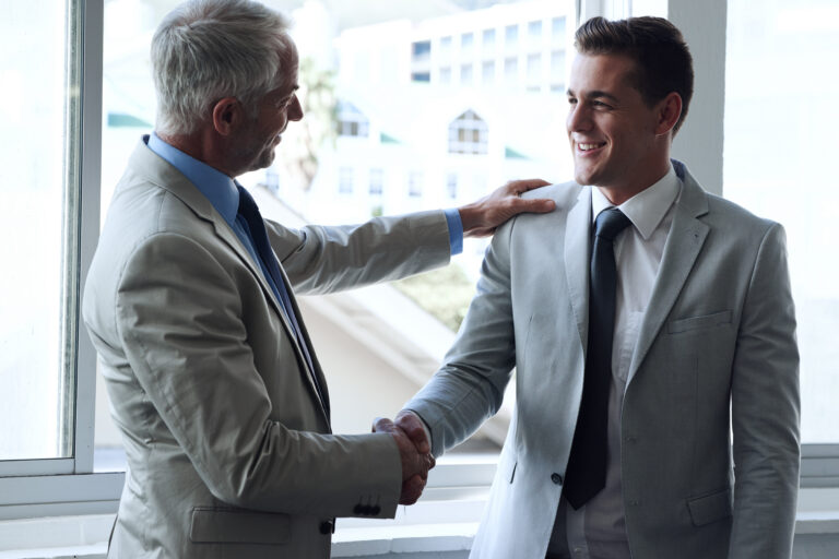 Letting agent and landlord shaking hands after compliance discussion