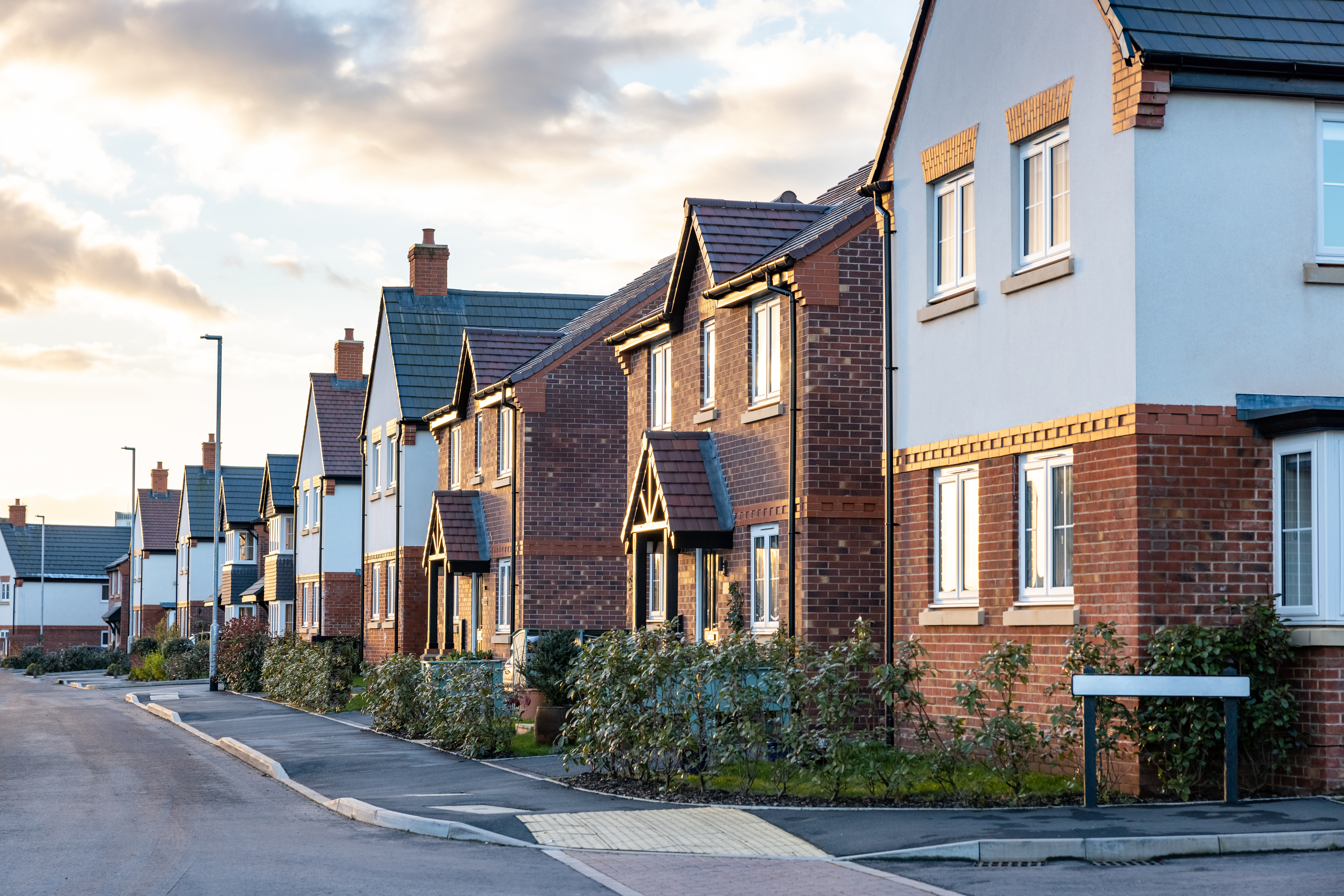 Row of modern new build houses in a suburban Aberdeen neighbourhood during sunset