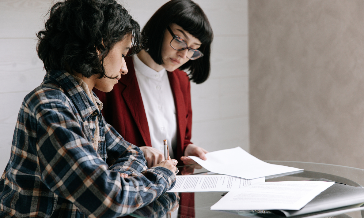 Tenant signing property documents with estate agent in Basford Stoke-on-Trent