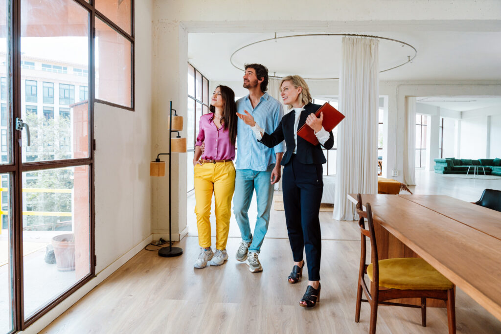 Estate agent showing a modern home to a young couple buying their first property in Stoke-on-Trent
