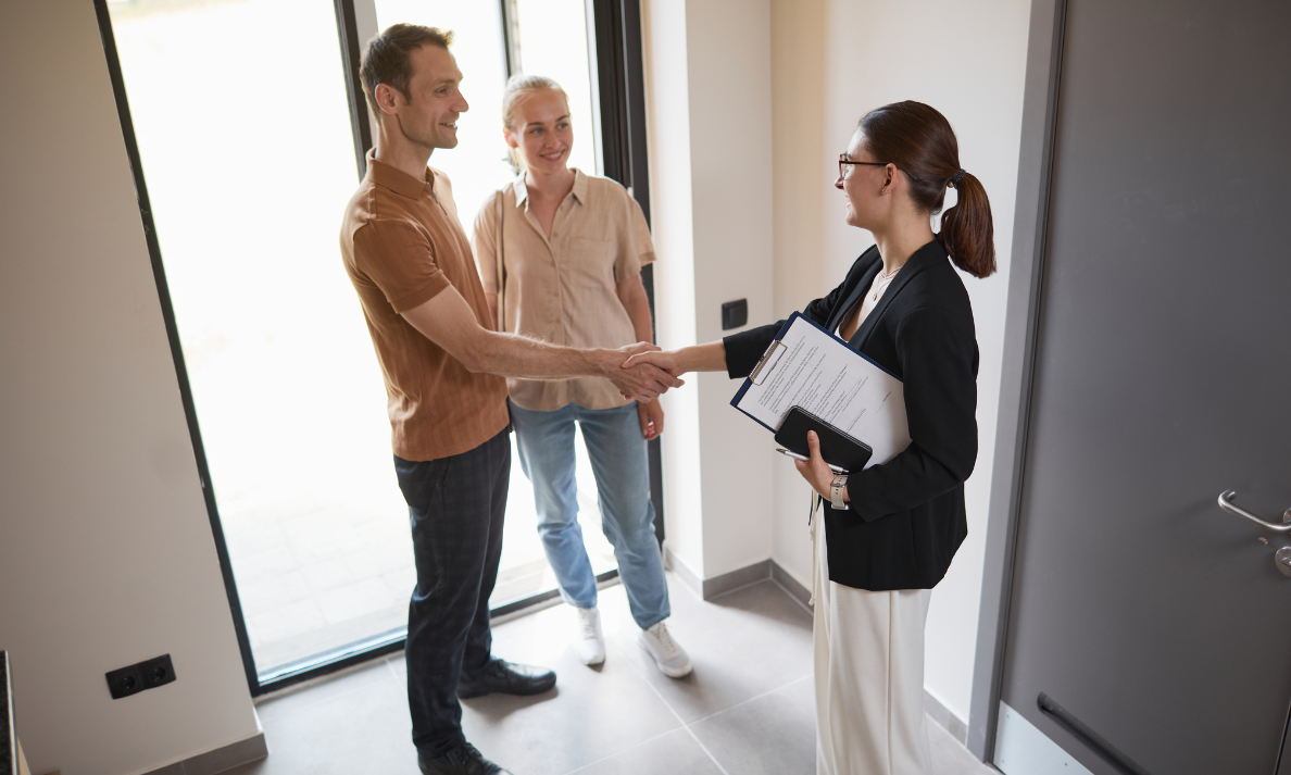 Letting agent shaking hands with tenants after agreeing a rental property in Solihull