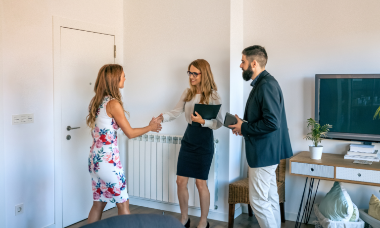 landlord or letting agent shaking hands with tenant inside rental property Solihull