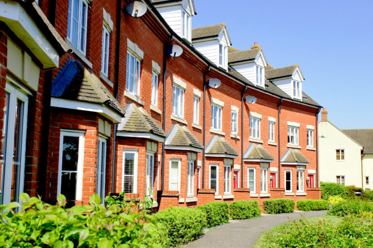 Row of modern red-brick houses in Welwyn Garden City showing typical AL7 residential development