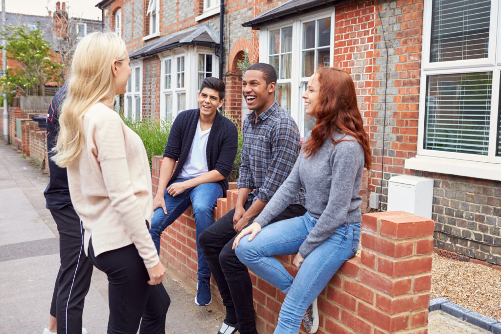 Group of students chatting outside a shared rental house in Worcester