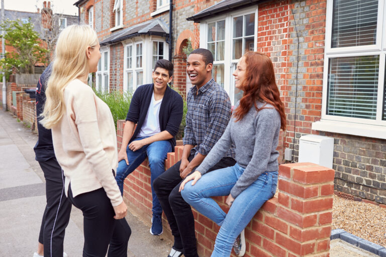 Group of students chatting outside a shared rental house in Worcester