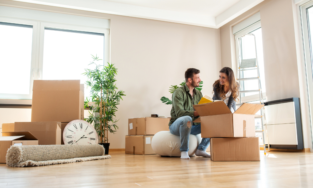 Young couple unpacking boxes in a new home in Leamington Spa CV31 as first-time buyers