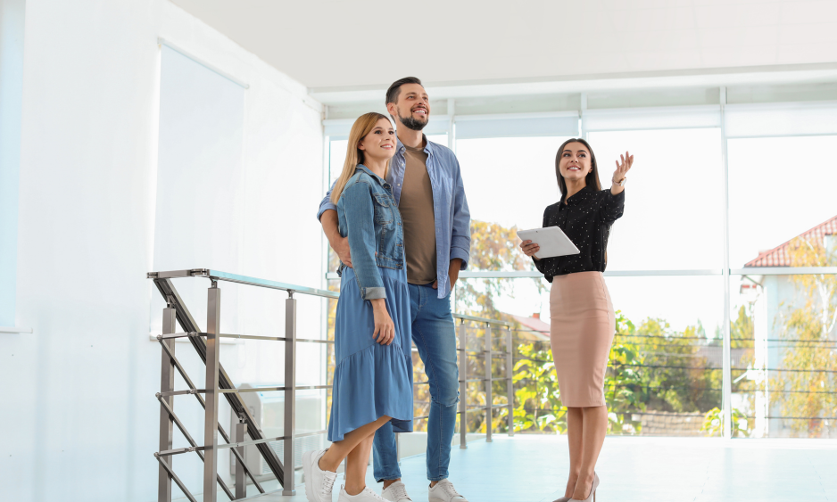 Estate agent showing a modern property to a couple during an HMO property viewing in Bath.