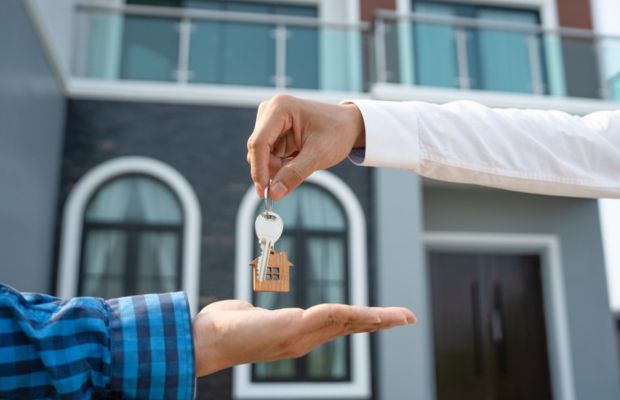 Handing over house keys to another person.