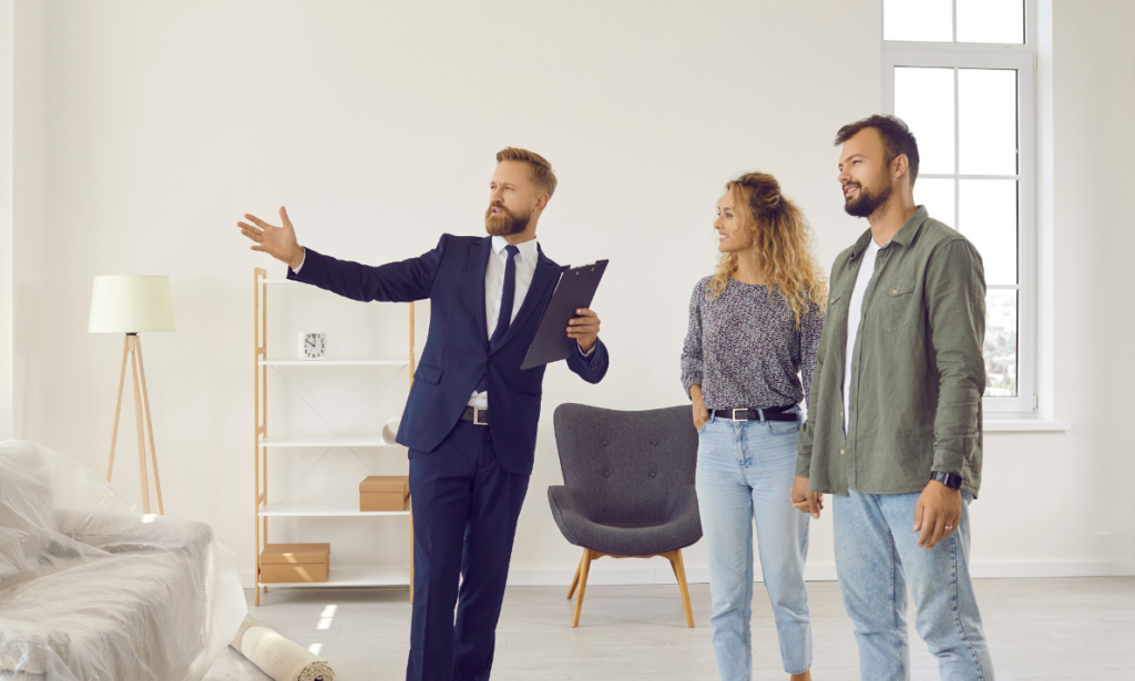 Estate agent showing a bright family home to buyers in Kings Park Stirling property market