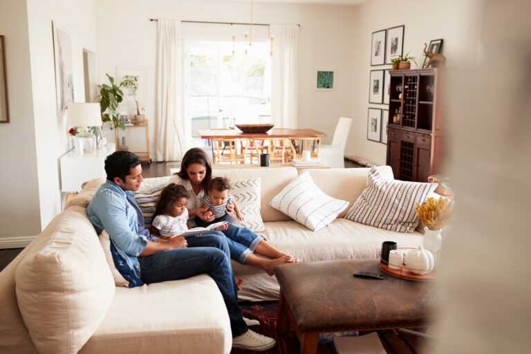 Young family relaxing together in a modern Westbury home living room in BA13