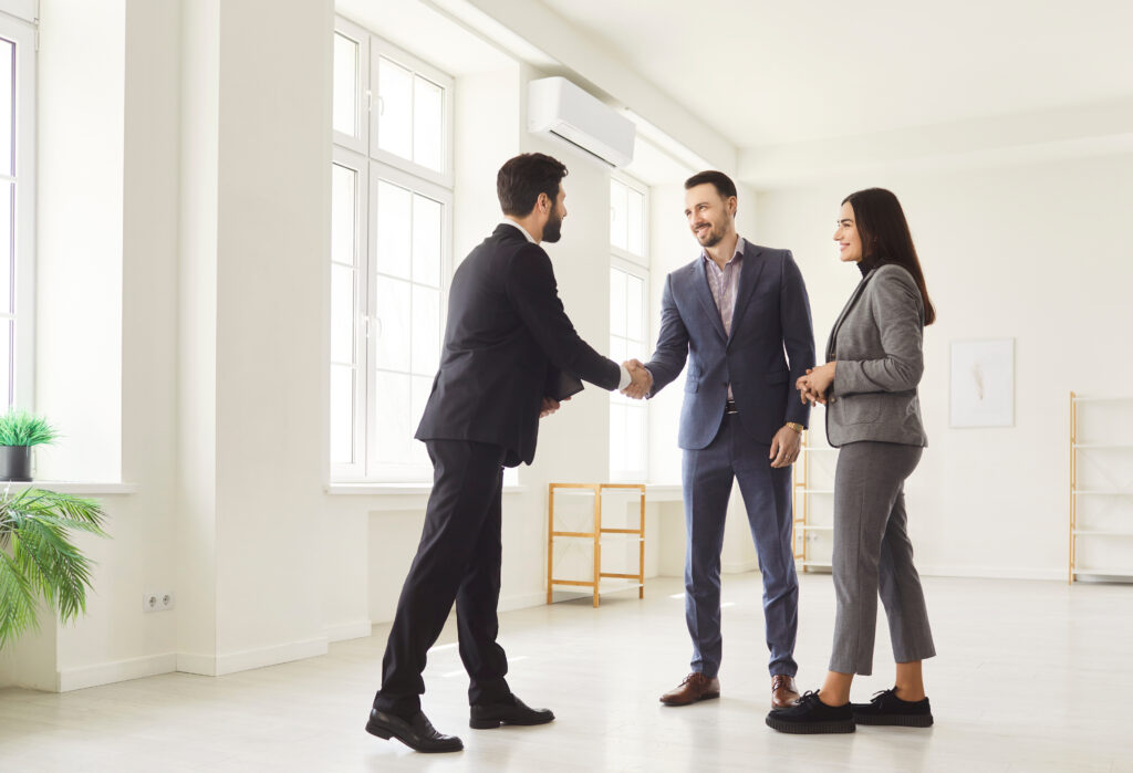 Estate agent meeting with a couple inside a rental property in Westbury during a property viewing.
