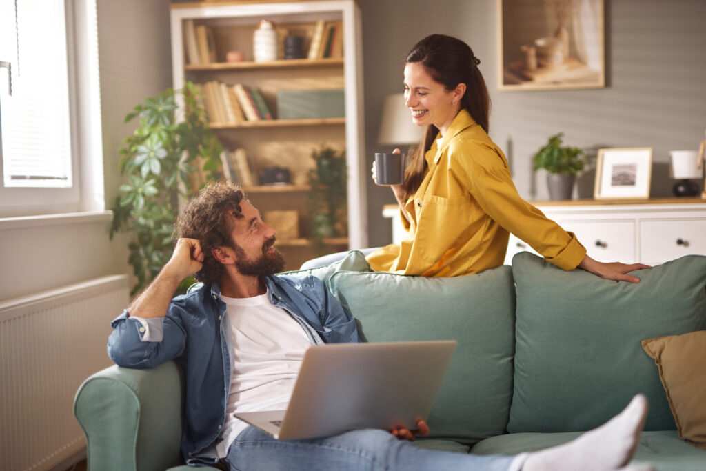 Couple reviewing property options on a laptop at home, representing first-time buyers searching in Stoke-on-Trent.