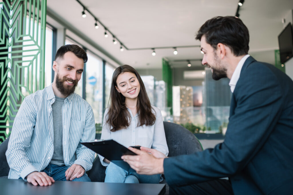 Estate agent meeting with a couple to discuss buying or selling a property in Southampton, reflecting local house prices and market conditions in 2026.