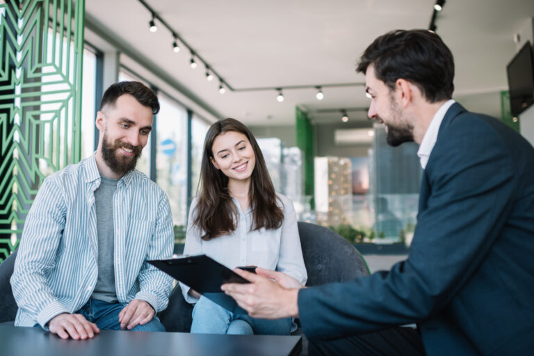 Estate agent meeting with a couple to discuss buying or selling a property in Southampton, reflecting local house prices and market conditions in 2026.