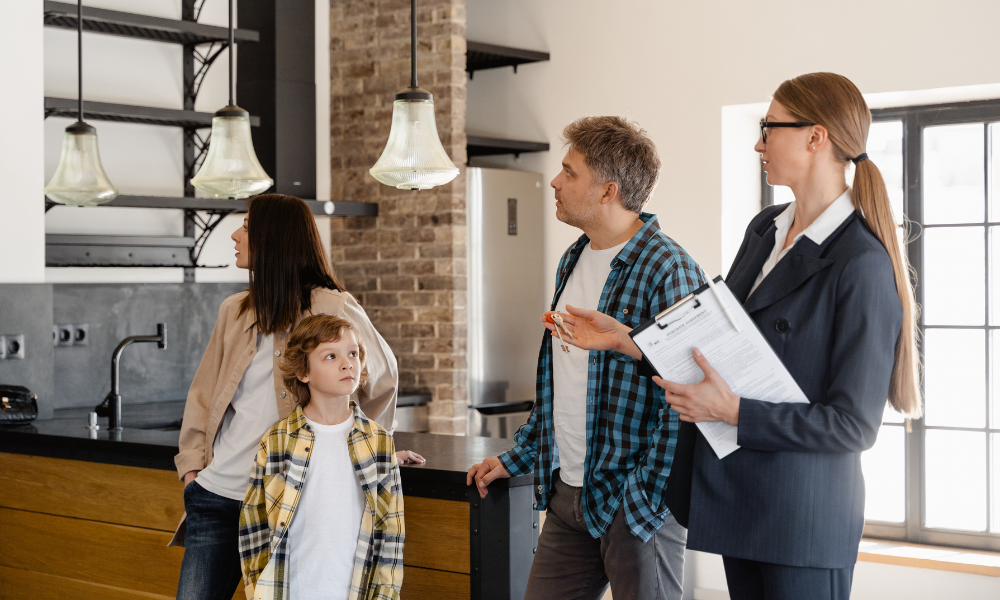 A family viewing a modern home with a property agent, representing buyers and renters exploring property options while living in Stirling FK8.