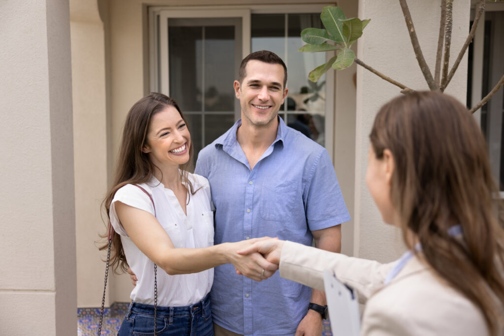 Letting agent greeting tenants outside a rental property, representing Making Tax Digital support for Dunfermline landlords and property management.