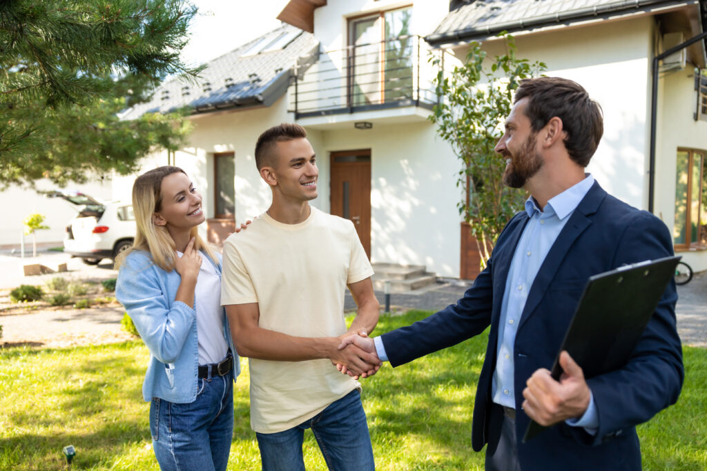 Letting agent meeting tenants outside a rental property, representing Making Tax Digital support for Paisley landlords and buy-to-let property management.