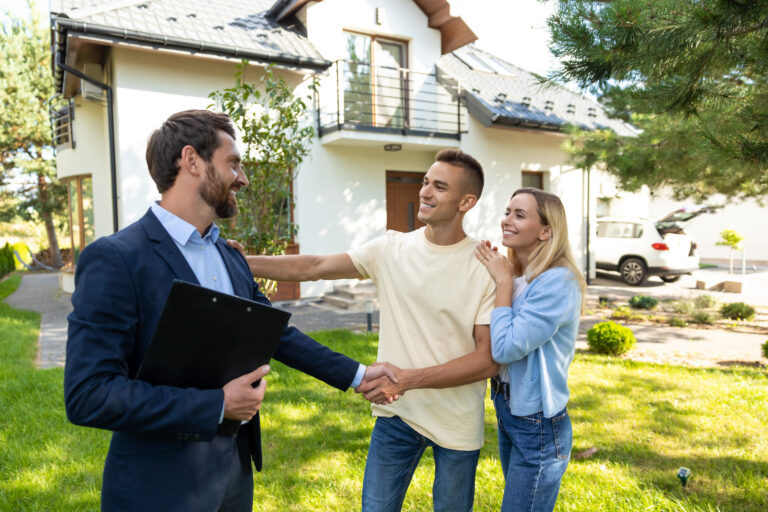 Letting agent greeting tenants outside a rental property, representing selective licensing in Stoke-on-Trent, landlord compliance and property management.