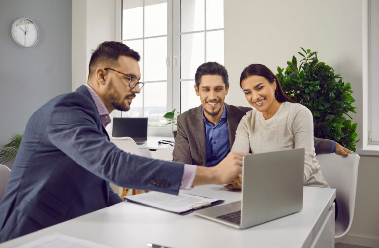 Letting agent discussing property details with clients using a laptop, representing Shrub Hill Quarter Worcester landlord advice, rental demand and property management.