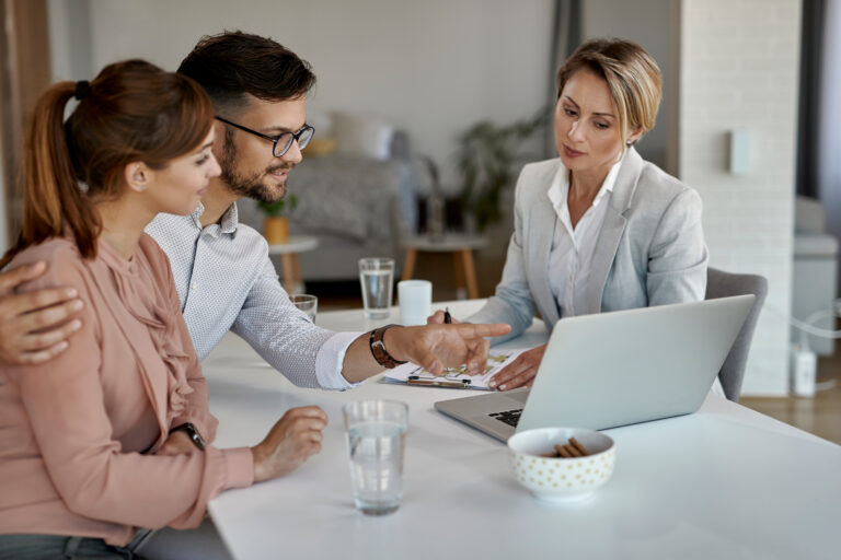 Letting agent discussing property details with clients inside a rental home, representing Southampton landlord advice, rental yields and property management.