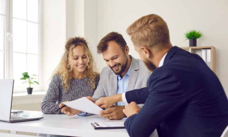 Estate agent discussing property details with a couple in Southampton, representing buying, renting and investing opportunities in Portswood SO17.