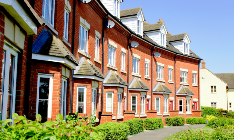Row of modern red-brick flats, representing Woking apartment buyers comparing Sheerwater and town centre flat prices in 2026.