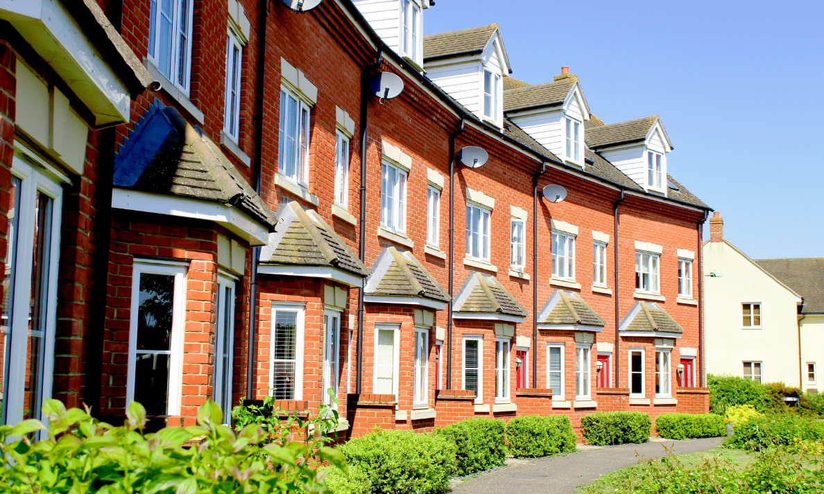 Row of modern red-brick flats, representing Woking apartment buyers comparing Sheerwater and town centre flat prices in 2026.